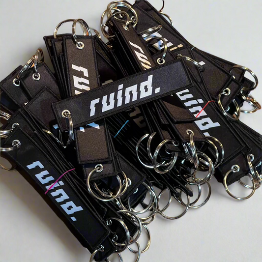 A pile of 'Ruind' jet tags, showcasing the bold front logo.  Perfect for adding a unique touch to keys or accessories.