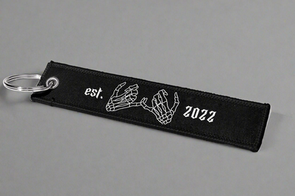 Jet tag back two skeleton hands linked together, along with 'EST. 2022' for an added touch of personalization and style.